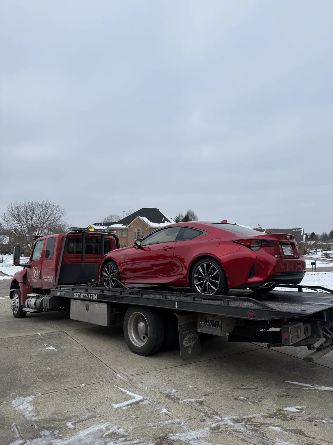 JJ’s flatbed transporting a red car