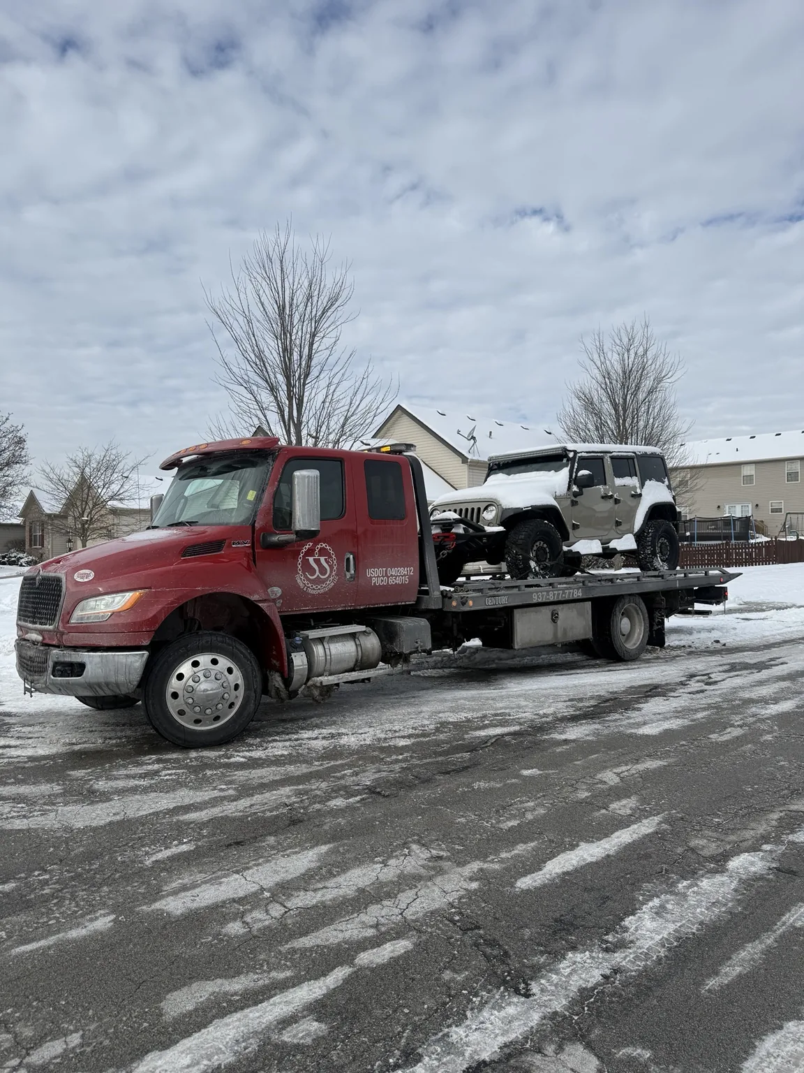 JJ’s flatbed carrying a white off-road vehicle