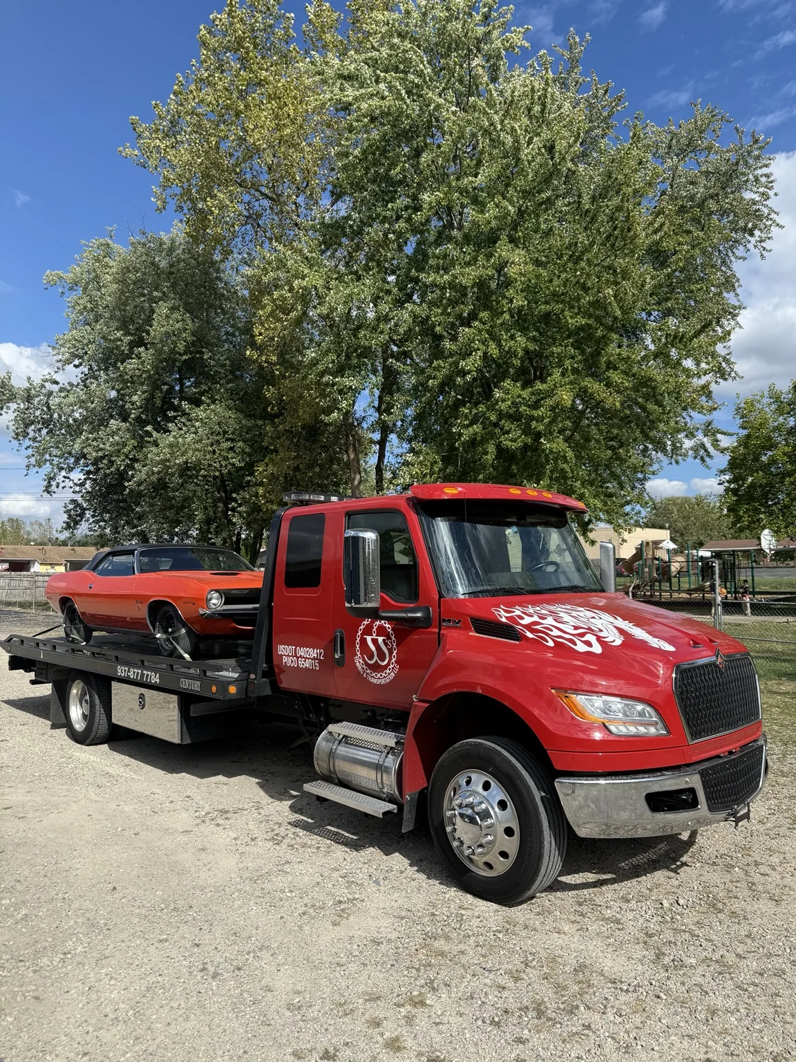 JJ’s flatbed carrying a classic orange car